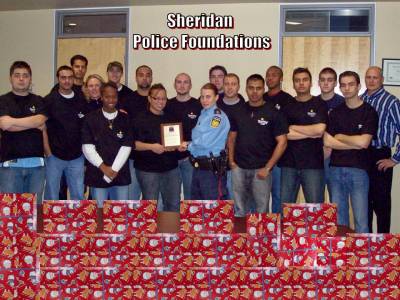Erin 'The Slick' Korslick presenting an 'Appreciation Plaque' to the students of the Sheridan College Police Foundation class.